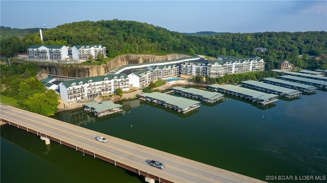 drone / aerial view featuring a water view and a forest view