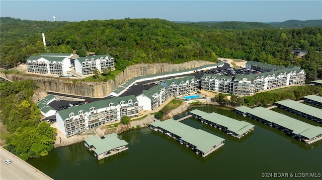 birds eye view of property featuring a water view and a forest view