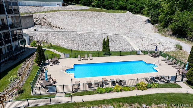 community pool featuring a patio area and fence