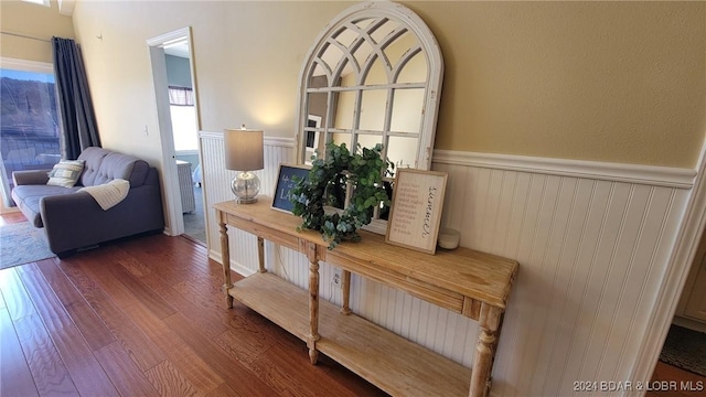 interior space with a wainscoted wall and wood finished floors