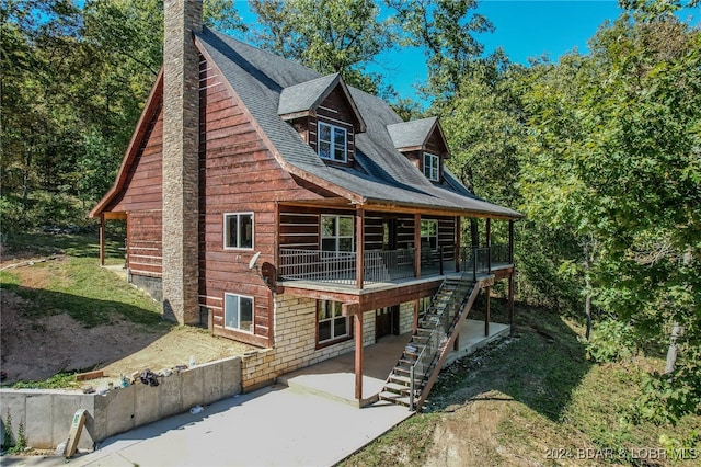 exterior space featuring a patio area and a wooden deck