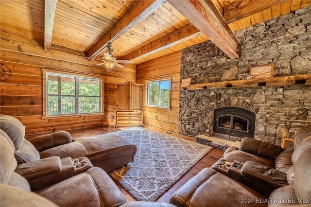 living room featuring a wealth of natural light, beamed ceiling, wooden ceiling, and hardwood / wood-style flooring