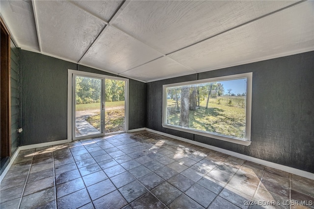 unfurnished room featuring lofted ceiling