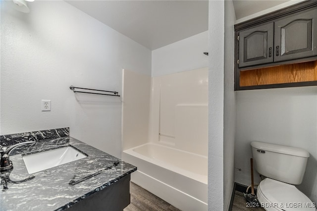 full bathroom featuring wood-type flooring, vanity, toilet, and tub / shower combination