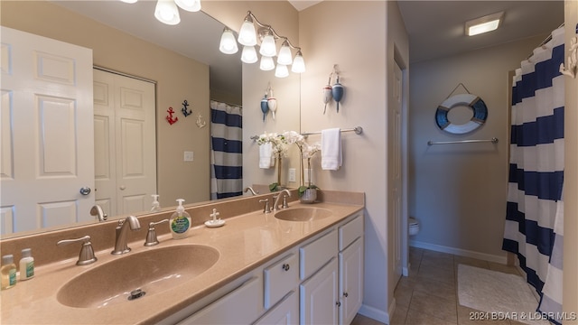 bathroom with tile patterned flooring, curtained shower, vanity, and toilet