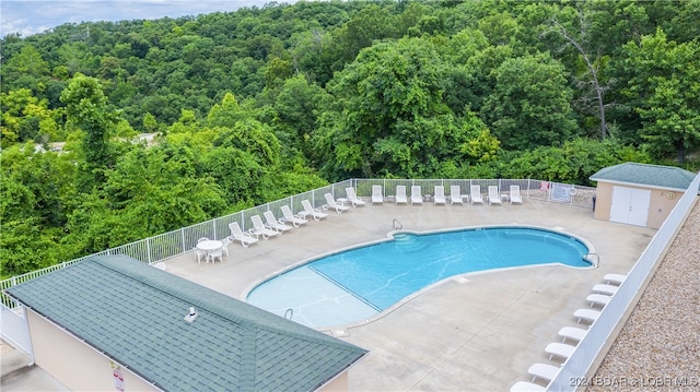 view of swimming pool with an outdoor structure and a patio