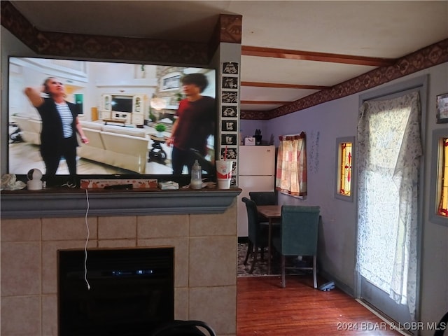 kitchen featuring white refrigerator, hardwood / wood-style flooring, and a fireplace