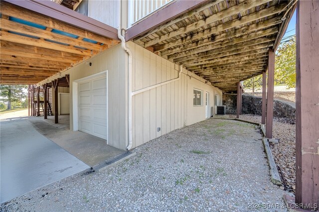 exterior space featuring central AC unit and a garage