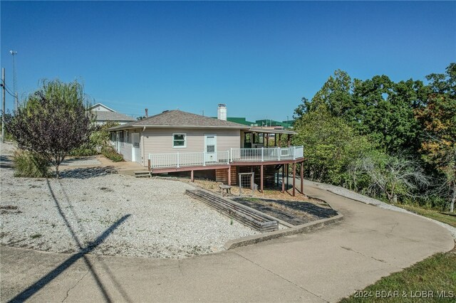 rear view of house featuring a deck