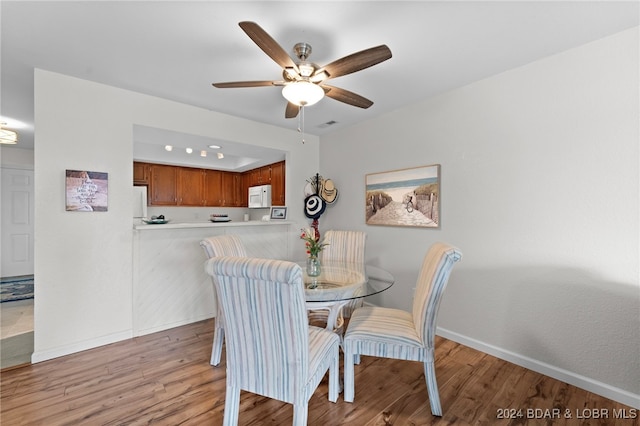 dining area featuring ceiling fan and light wood-type flooring