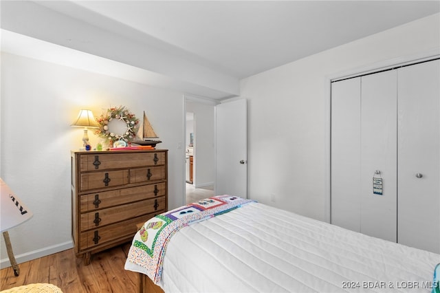 bedroom with a closet and light hardwood / wood-style flooring