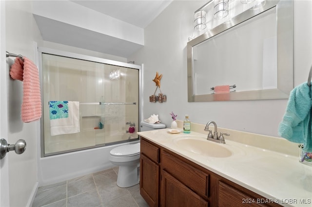 full bathroom with toilet, vanity, tile patterned floors, and combined bath / shower with glass door