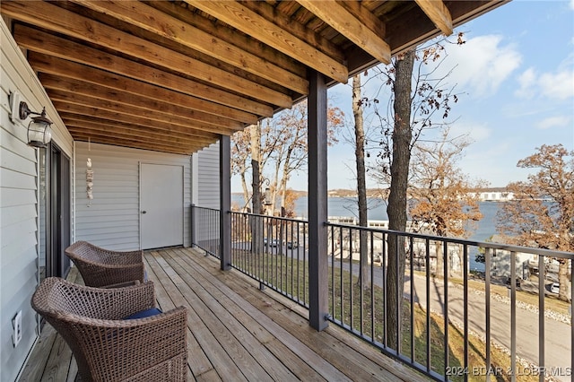 wooden deck featuring a water view