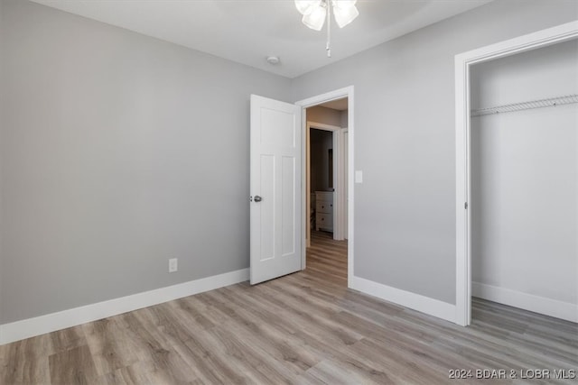 unfurnished bedroom featuring a closet and light hardwood / wood-style floors