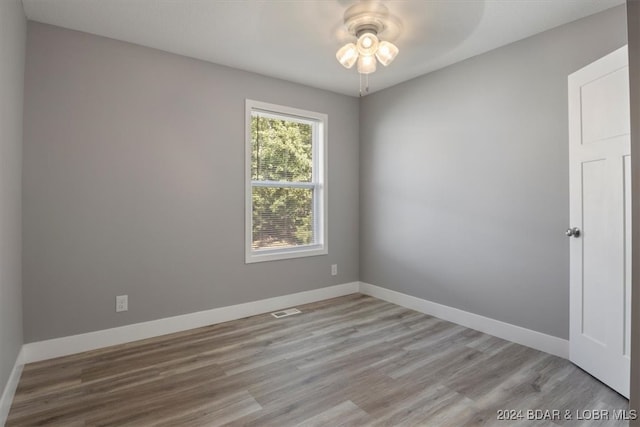 empty room featuring ceiling fan and light hardwood / wood-style flooring