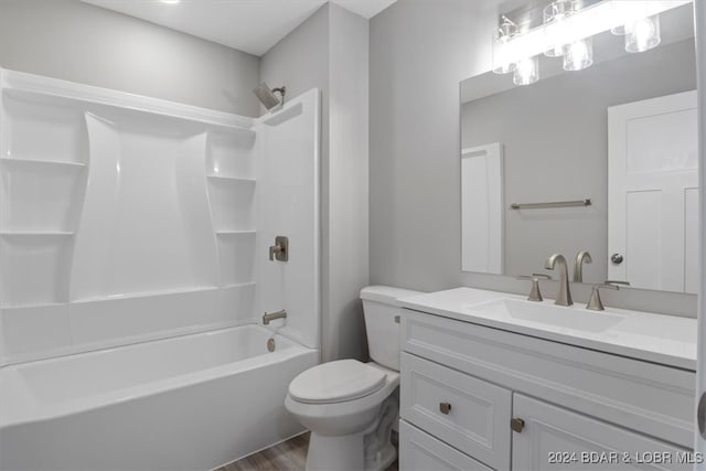 full bathroom with hardwood / wood-style floors, toilet, shower / bathtub combination, and vanity