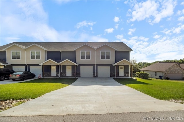 view of front of house featuring a garage and a front yard