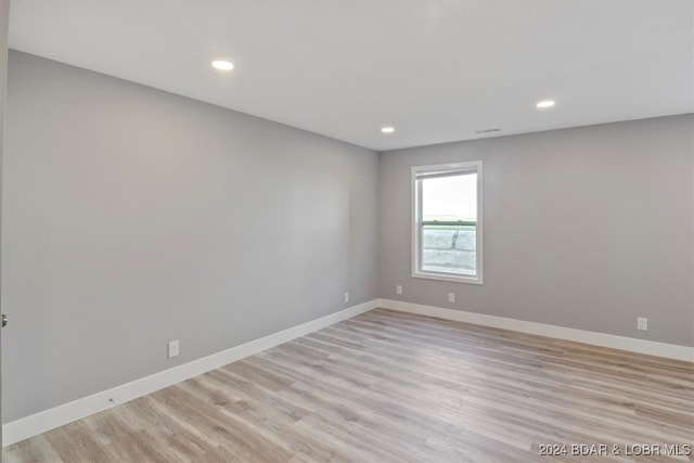 spare room featuring light hardwood / wood-style floors