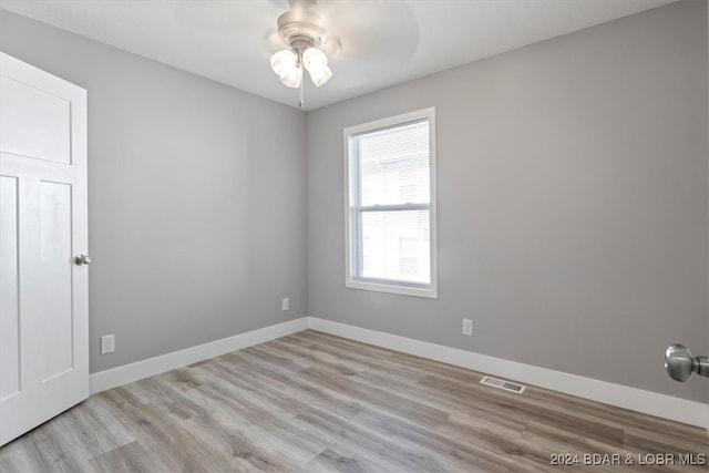 empty room with light hardwood / wood-style floors and ceiling fan