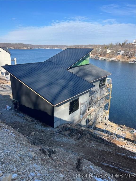 view of property exterior featuring a water view