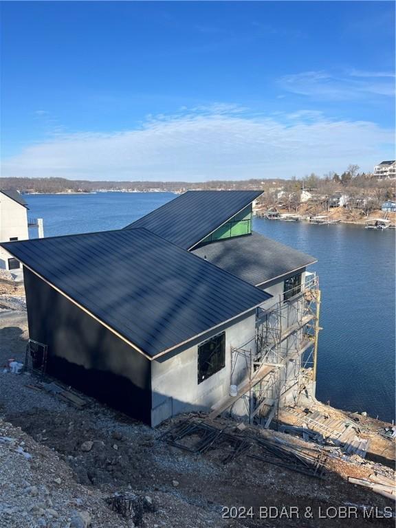 view of side of home with a water view