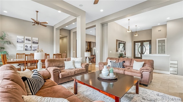 living room featuring a towering ceiling and ceiling fan