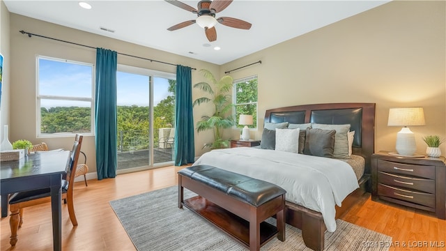 bedroom with light wood-type flooring, ceiling fan, and access to exterior