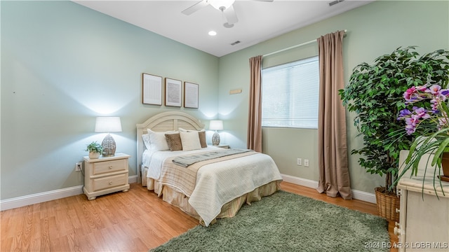 bedroom featuring light hardwood / wood-style flooring and ceiling fan