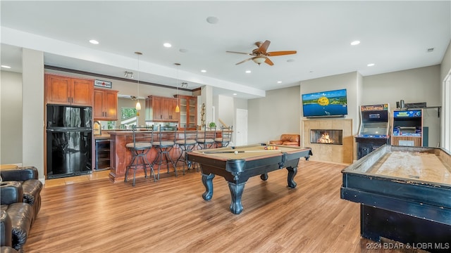 rec room with light hardwood / wood-style floors, billiards, wine cooler, a fireplace, and ceiling fan