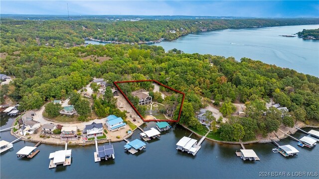 birds eye view of property with a water view