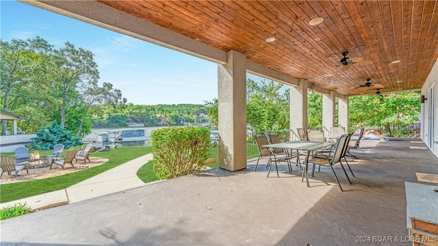 view of patio / terrace with ceiling fan and an outdoor fire pit