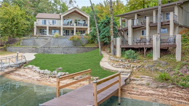 exterior space with a balcony and a yard