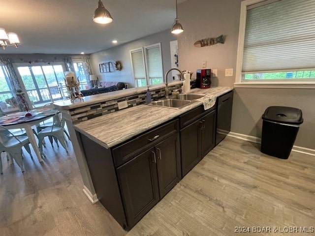 kitchen with kitchen peninsula, sink, and plenty of natural light