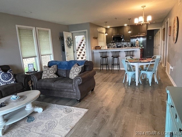 living room featuring a chandelier and dark hardwood / wood-style flooring