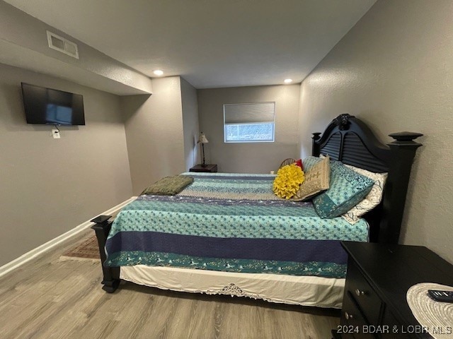 bedroom with hardwood / wood-style flooring