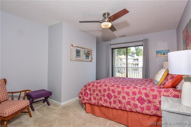 carpeted bedroom with a textured ceiling, ceiling fan, and access to exterior