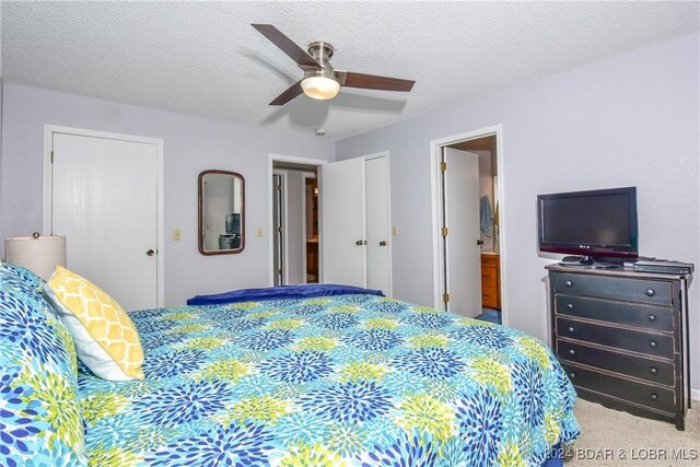 bedroom featuring ceiling fan, carpet floors, and a textured ceiling