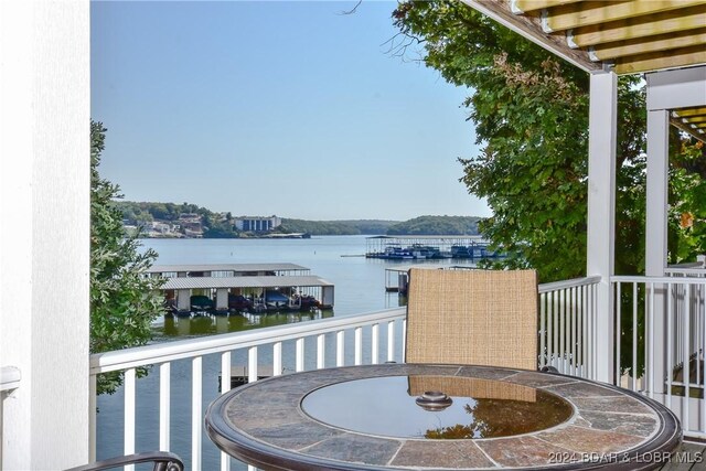 803 Winn Rd Unit 7E, Osage Beach, MO 65065 - balcony featuring a water view and outdoor dining space