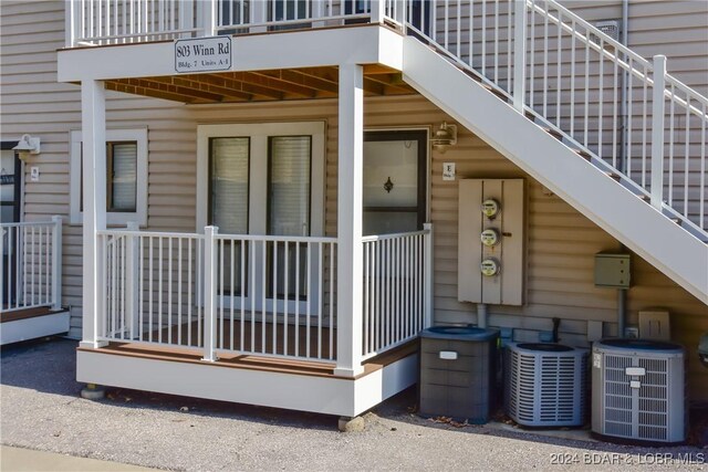 doorway to property with a balcony and central air condition unit