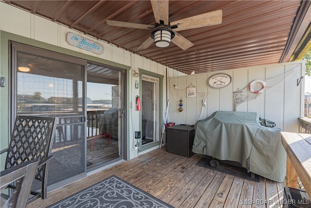 wooden deck with a grill and ceiling fan