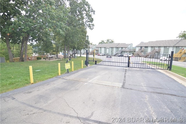 view of gate featuring a lawn