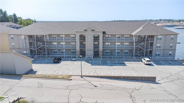 view of building exterior with uncovered parking