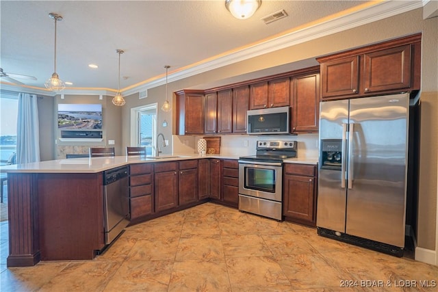 kitchen featuring visible vents, appliances with stainless steel finishes, decorative light fixtures, light countertops, and a sink