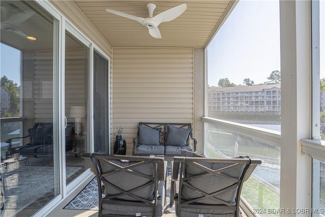 sunroom / solarium featuring ceiling fan