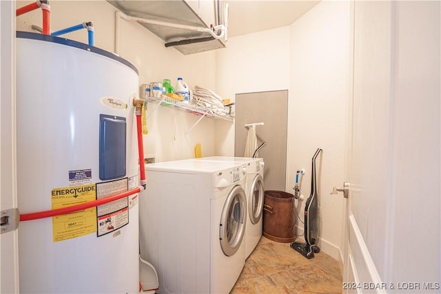 laundry area featuring washing machine and dryer, electric water heater, and laundry area