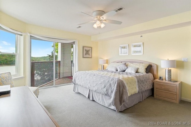 carpeted bedroom with ceiling fan, access to outside, and multiple windows