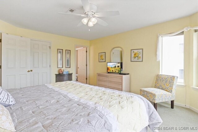 carpeted bedroom with ceiling fan