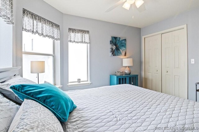 bedroom with ceiling fan and a closet