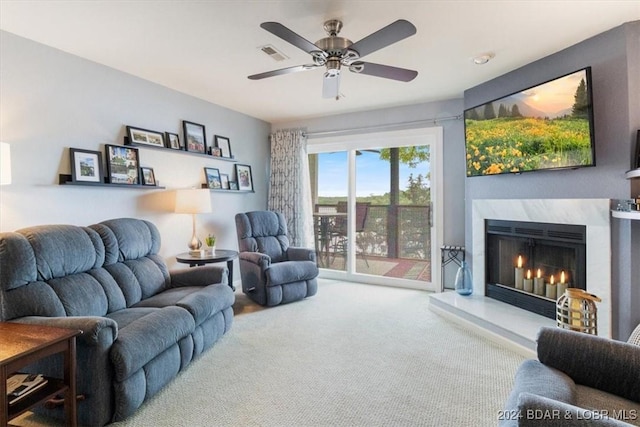 carpeted living room with ceiling fan