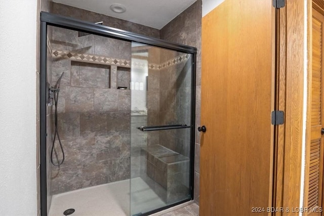 bathroom featuring a shower with shower door